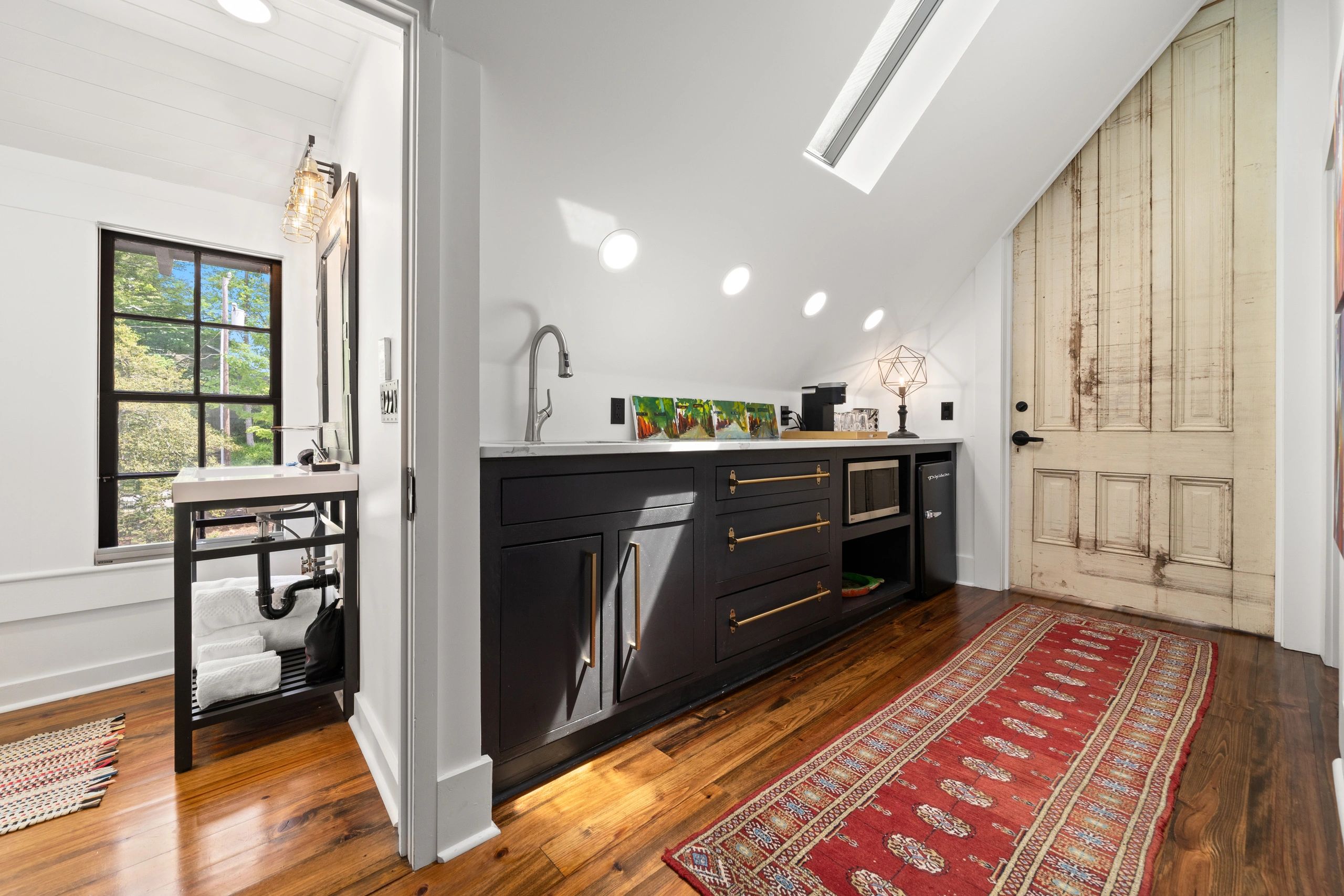 Elegant hallway with dark cabinetry and vintage accents
